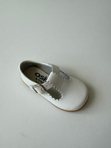 White scalloped leather t-strap shoe
