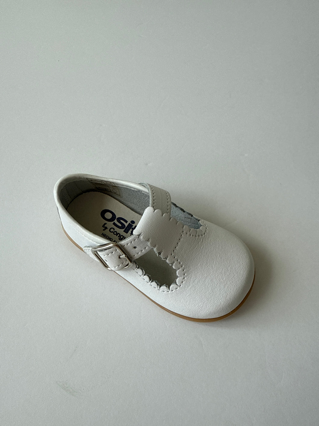 White scalloped leather t-strap shoe