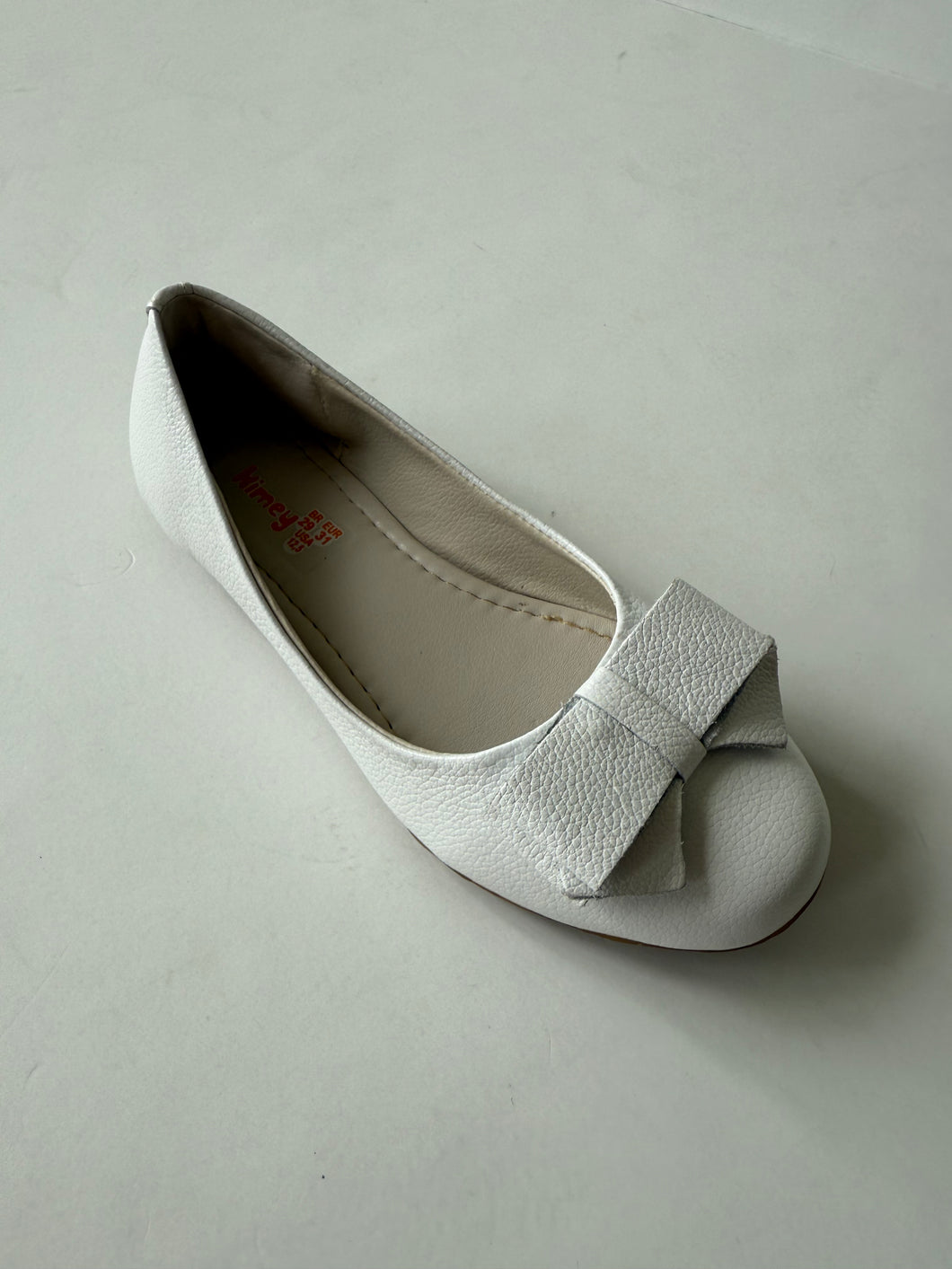 White ballet flat with bow